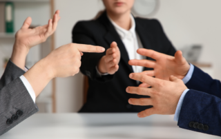 Leader helping navigate workplace conflict between two employees during a dispute.